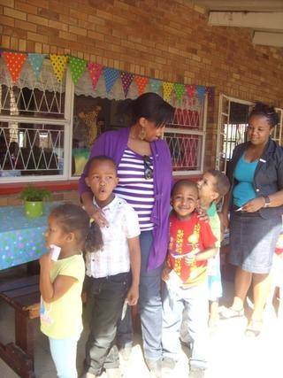 Ulutho is waiting in the qeue for tuckshop with Mommy Pamela.