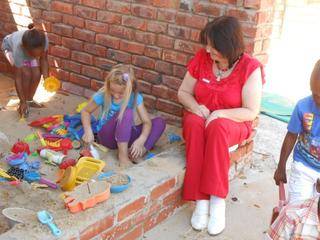 Jhanke and Ouma Beryl are playing the sandpit.