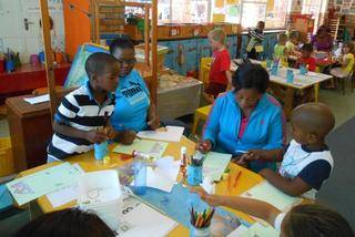 Sabelo, mom Mavis, Mom Nontobeko and Olwam are enjoying creative activities.