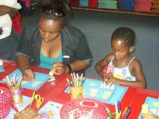 Mom Samela and Simphuthando enjoys cutting and pasting!